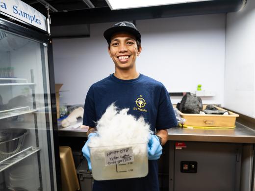 Kainalu holds a sample in the wetlab